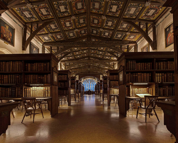 Huge mysterious library with bookstands, lots of books and tables