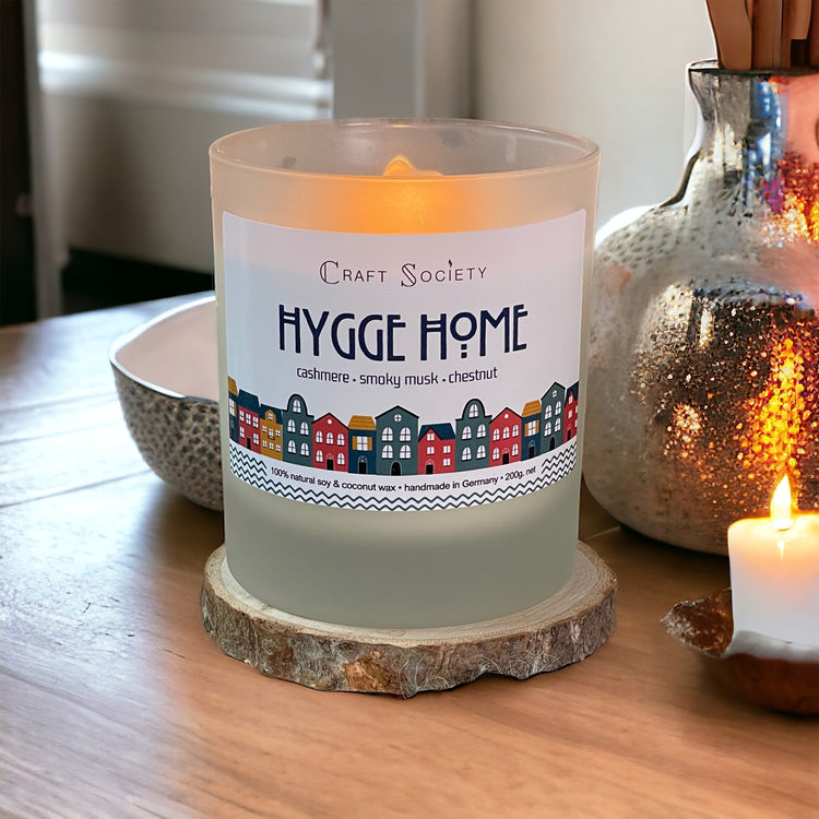 Our Hygge Home scented candle on a decorated cozy background