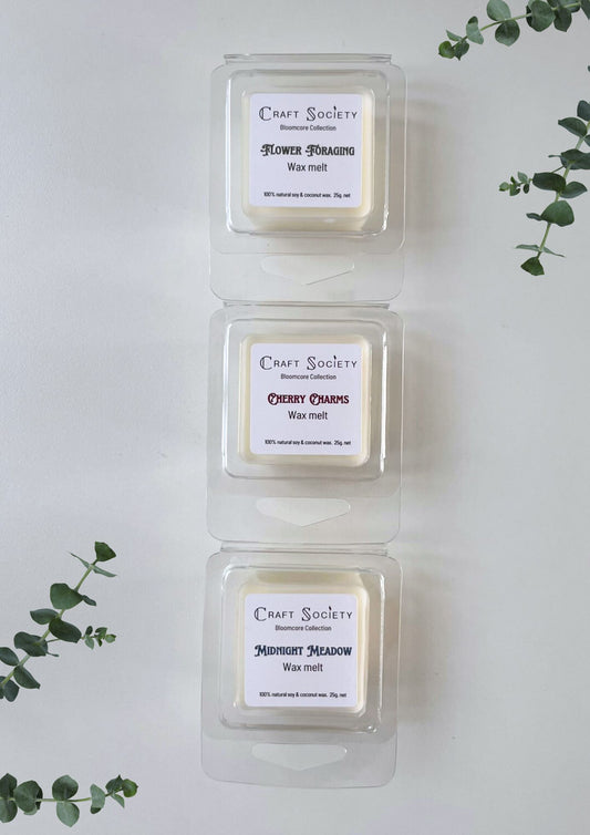 A set of wax melts with scents highlighting 3 candles from the Bloomcore collection
