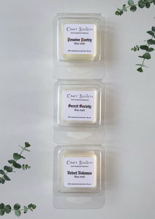 A set of wax melts with scents highlighting 3 candles from the Dark Academia collection