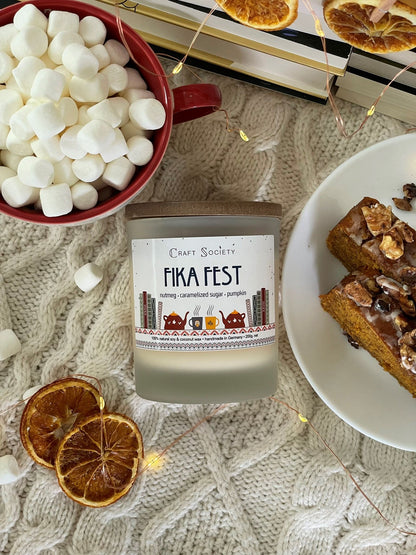 The Fika Fest scented candle with wooden wick from above on a festive background