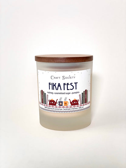 A burning deluxe scented candle on a white background sealed