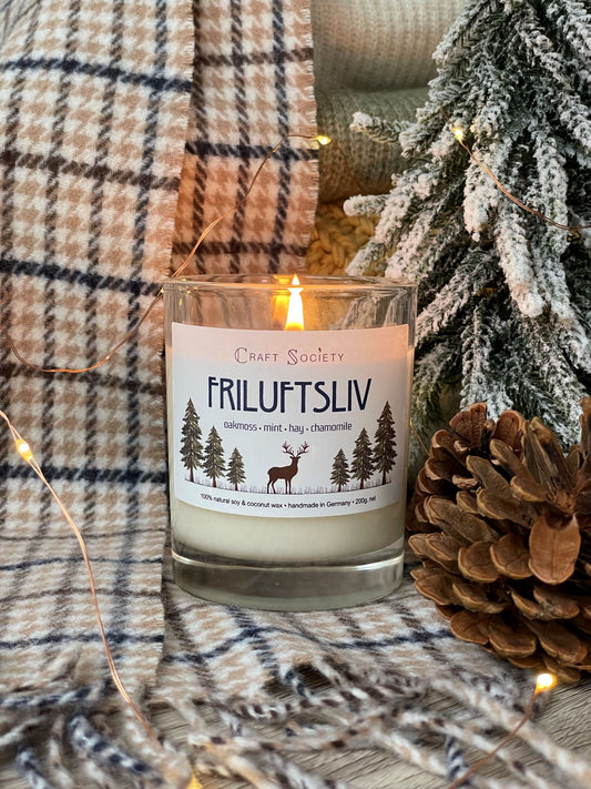 A burning scented candle made with premium fragrance oils on a decorated background