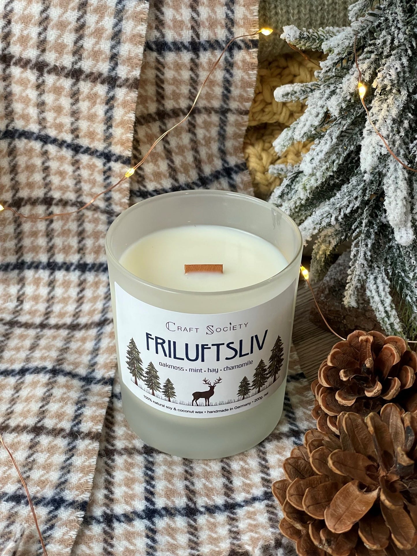 An unpacked deluxe scented candle on a decorated background