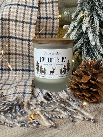 A brand new deluxe scented candle on a decorated background