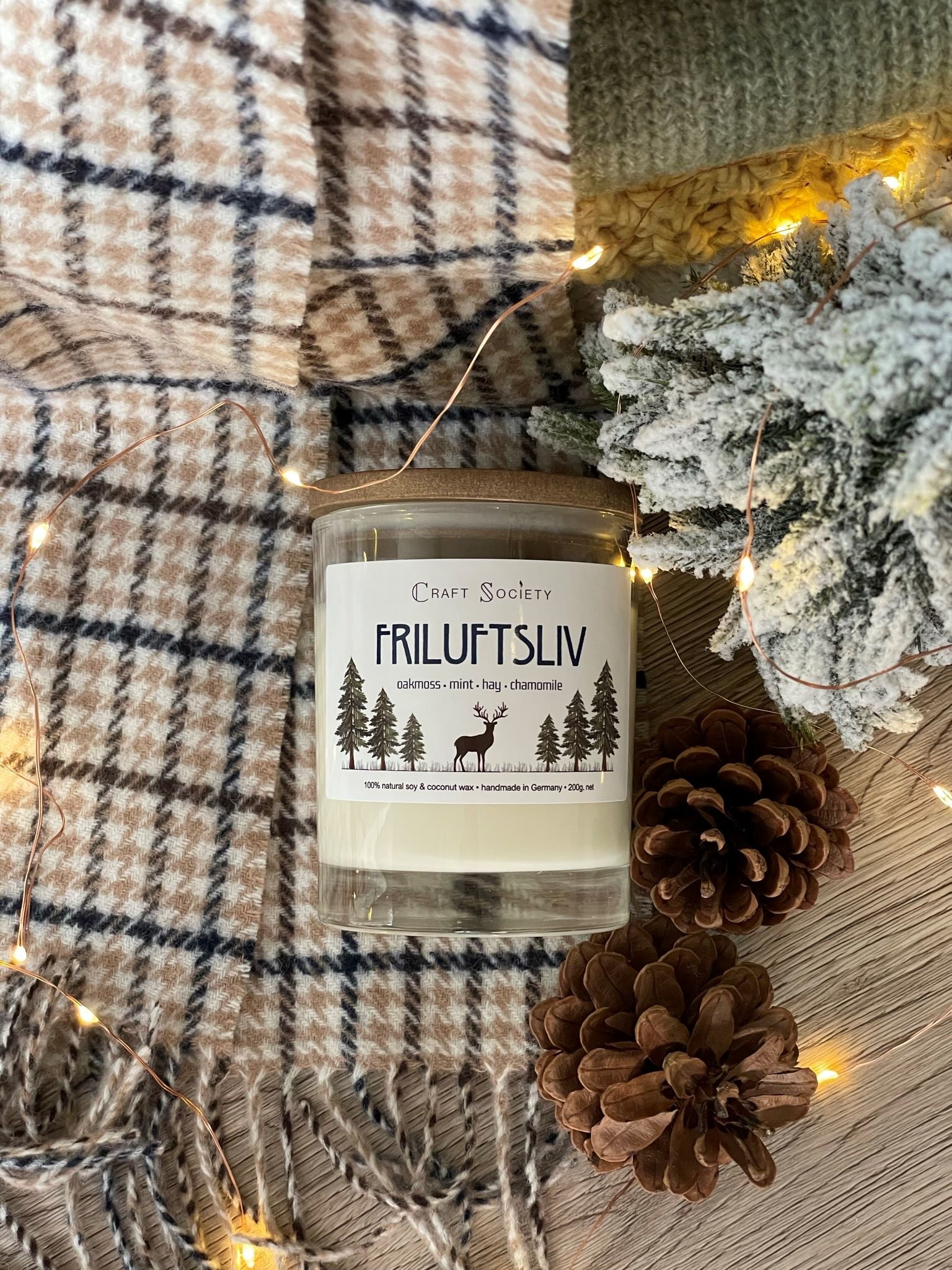 The Friluftsliv scented candle with cotton wick from above on a festive background