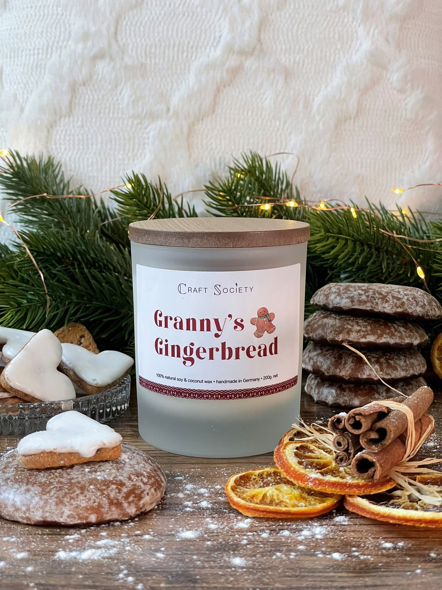 An unopened deluxe scented candle on a decorated background