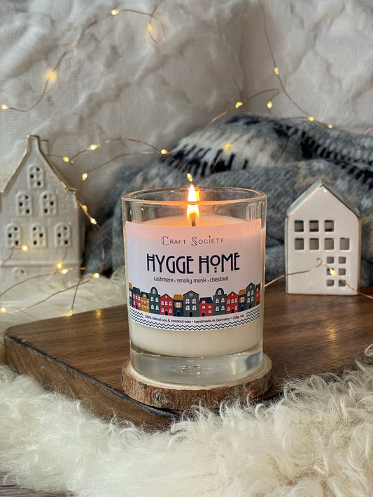 A lit scented candle made from vegetable wax on a decorated background