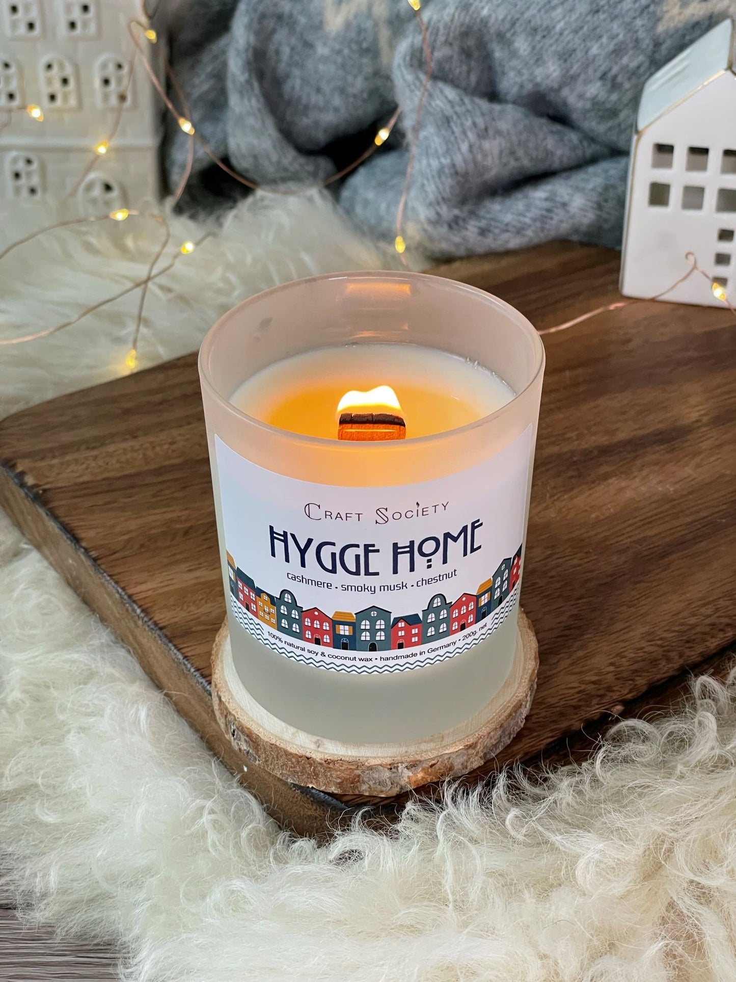 A burning deluxe scented candle made with premium fragrance oils on a decorated background