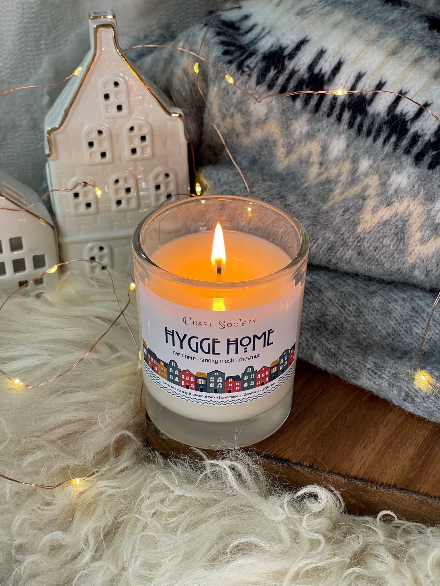 A burning scented candle made with premium fragrance oils on a decorated background