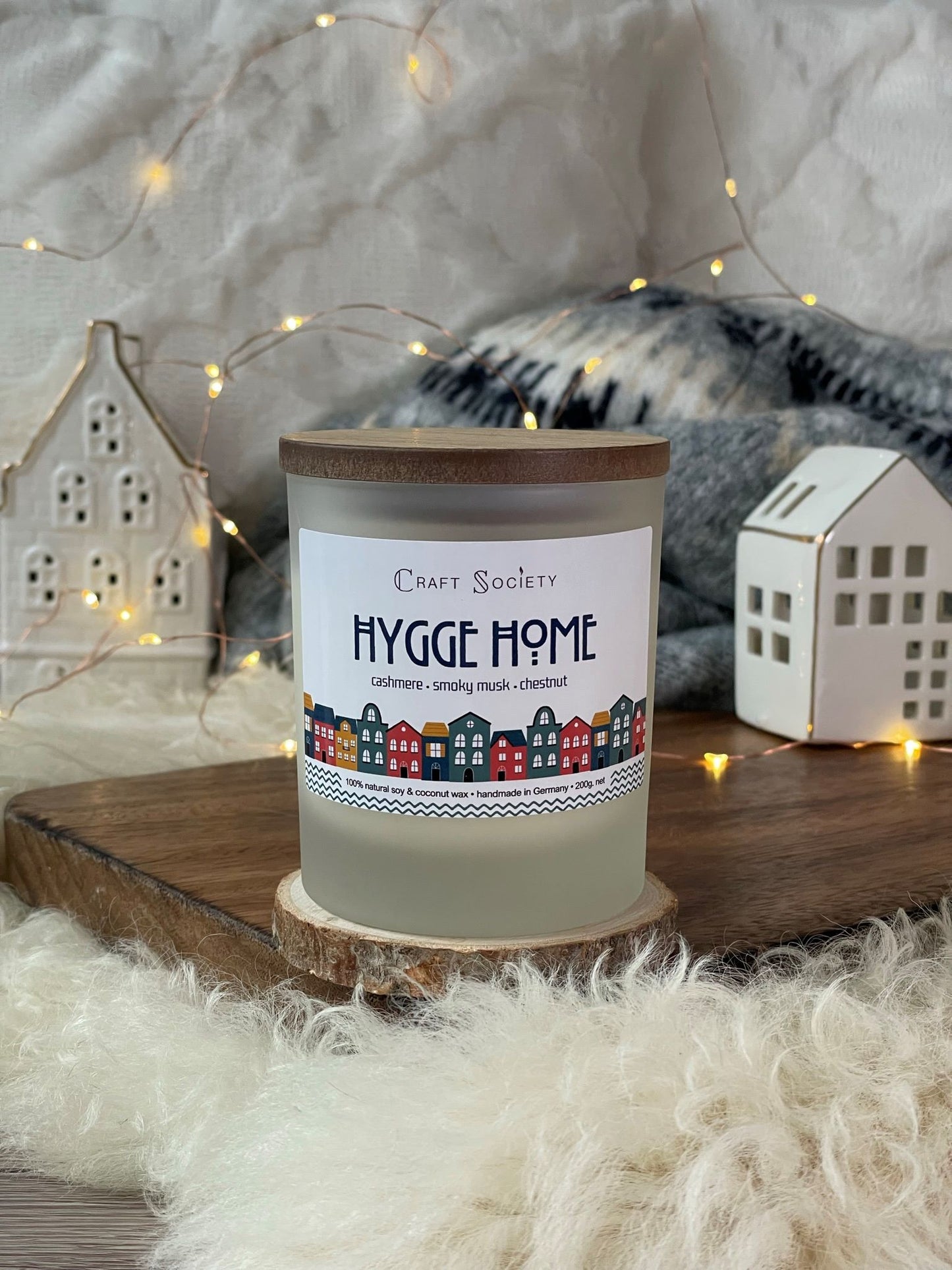 A brand new deluxe scented candle on a decorated background