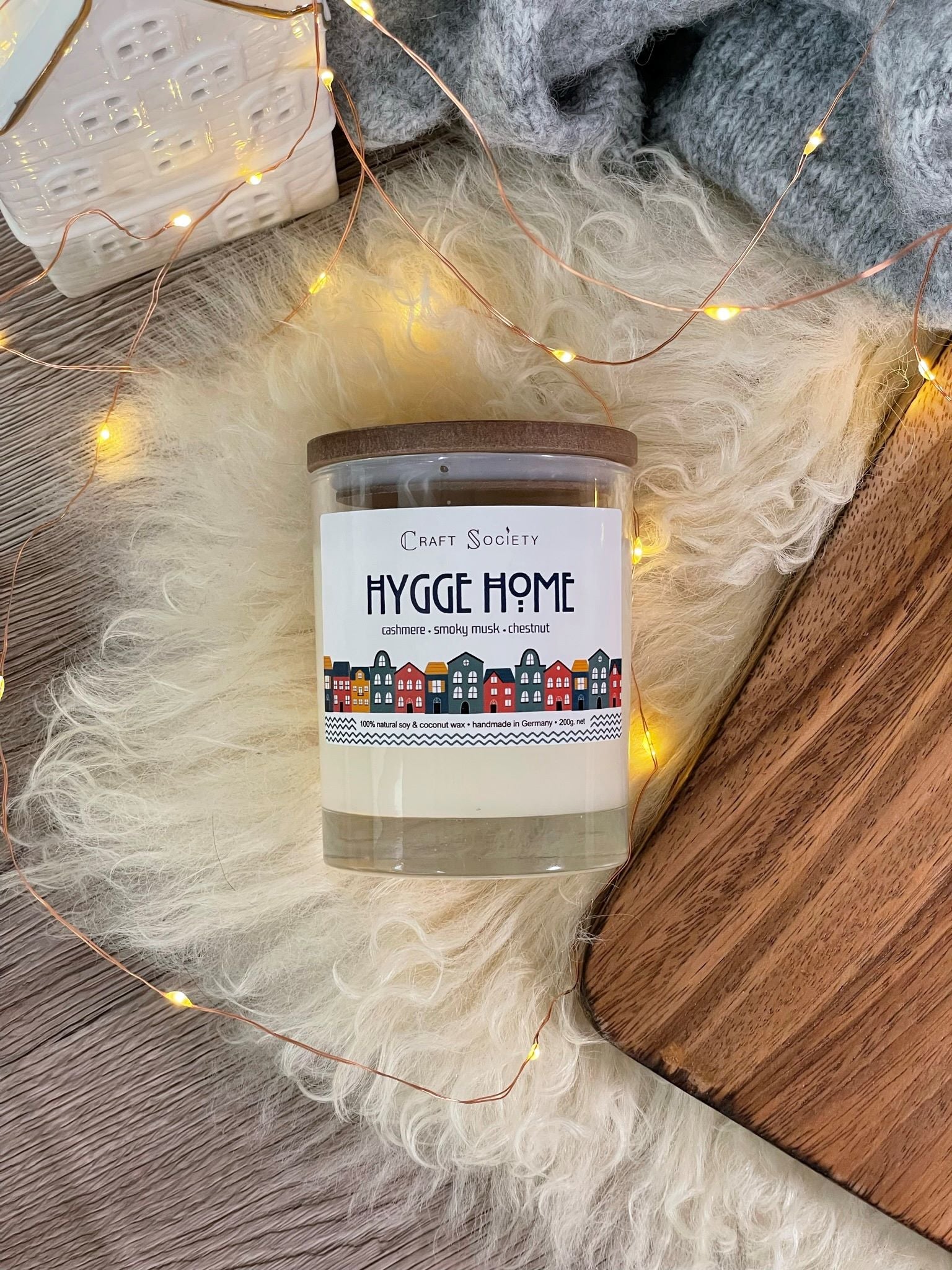 The Hygge Home scented candle with cotton wick from above on a festive background
