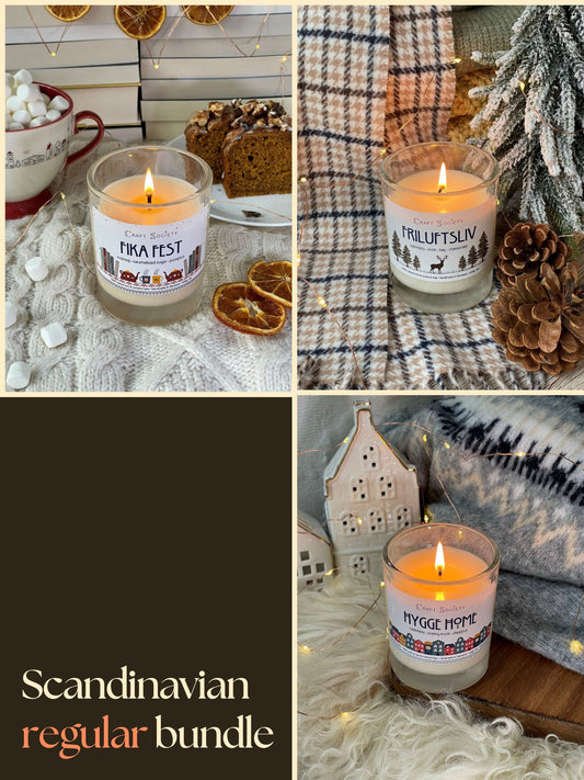 A bundle of three scented candles, all lit, clear jars, on a decorated background, scandinavian theme