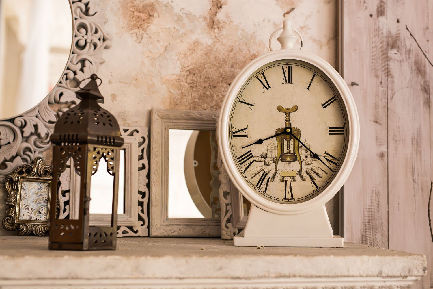 a vintage scene with an old clock, mirror, wooden-tapestry and old photo frames